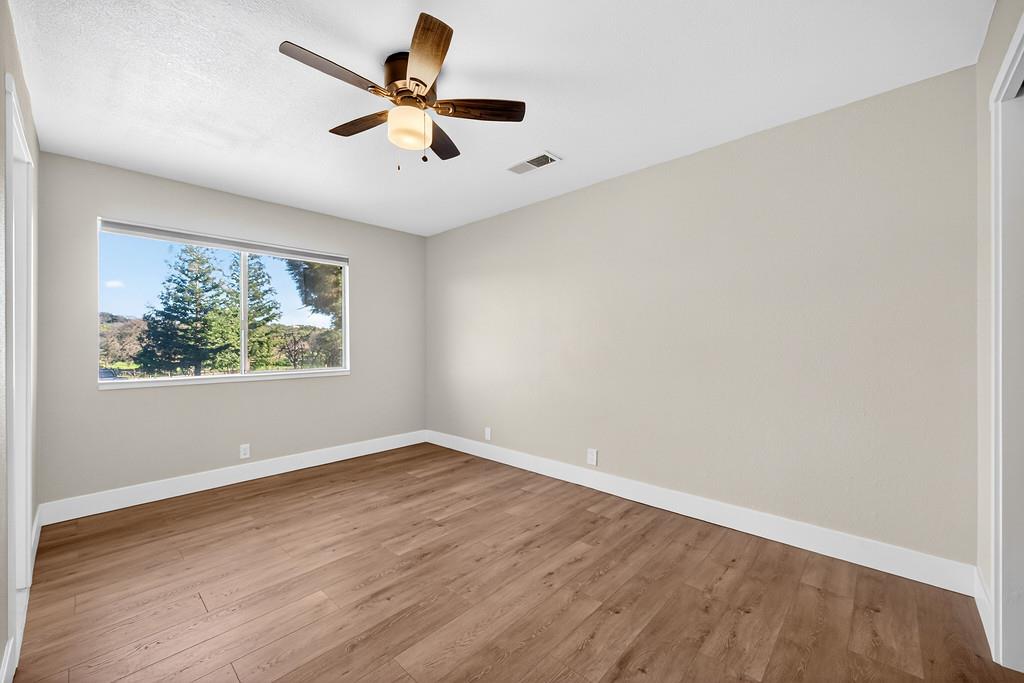 3901 Luneman Road Placerville, CA 95667 - Photo 20 of 56 an empty room with wooden floor and windows