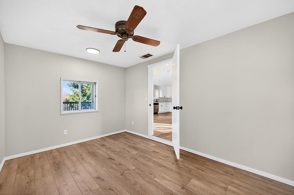 3901 Luneman Road Placerville, CA 95667 - Photo 24 of 56 an empty room with wooden floor and a ceiling fan