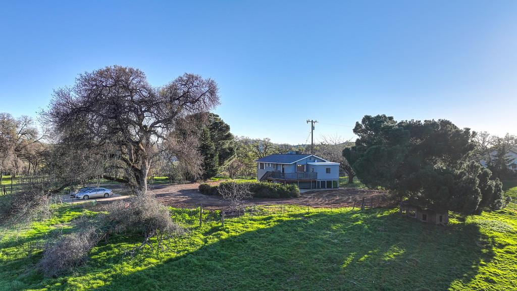 3901 Luneman Road Placerville, CA 95667 - Photo 39 of 56 a view of a backyard with lawn chairs under an umbrella