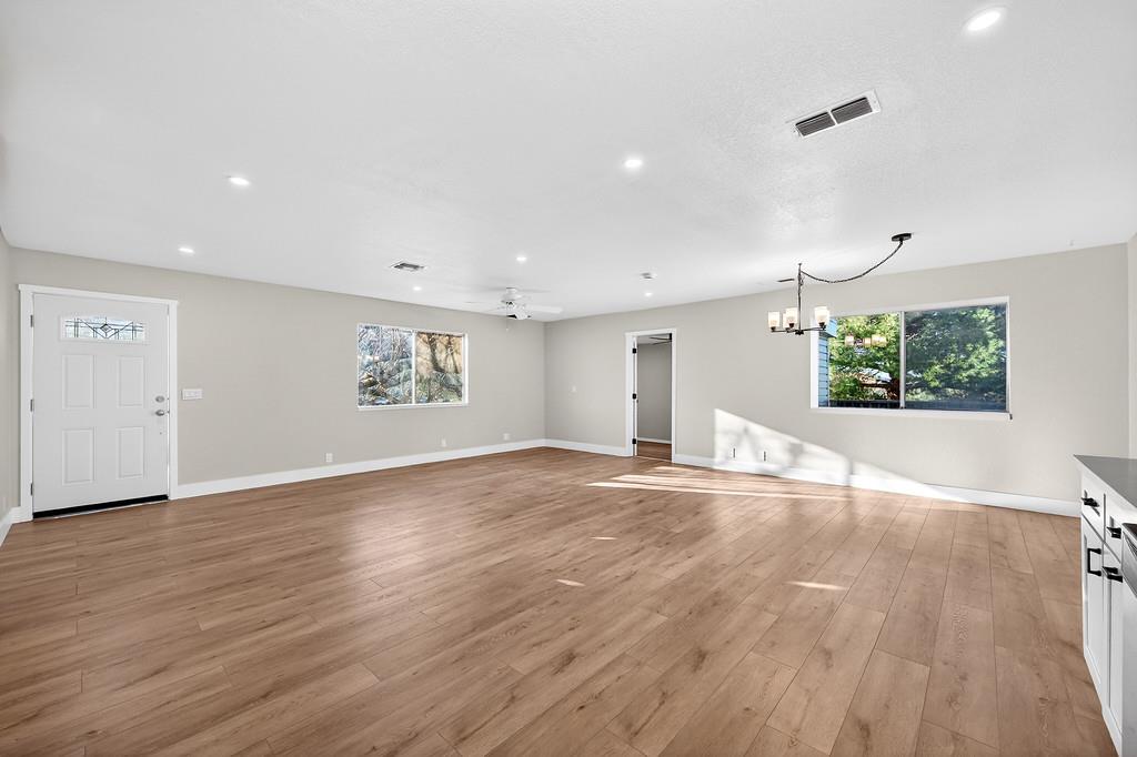 3901 Luneman Road Placerville, CA 95667 - Photo 8 of 56 an empty room with wooden floor and windows