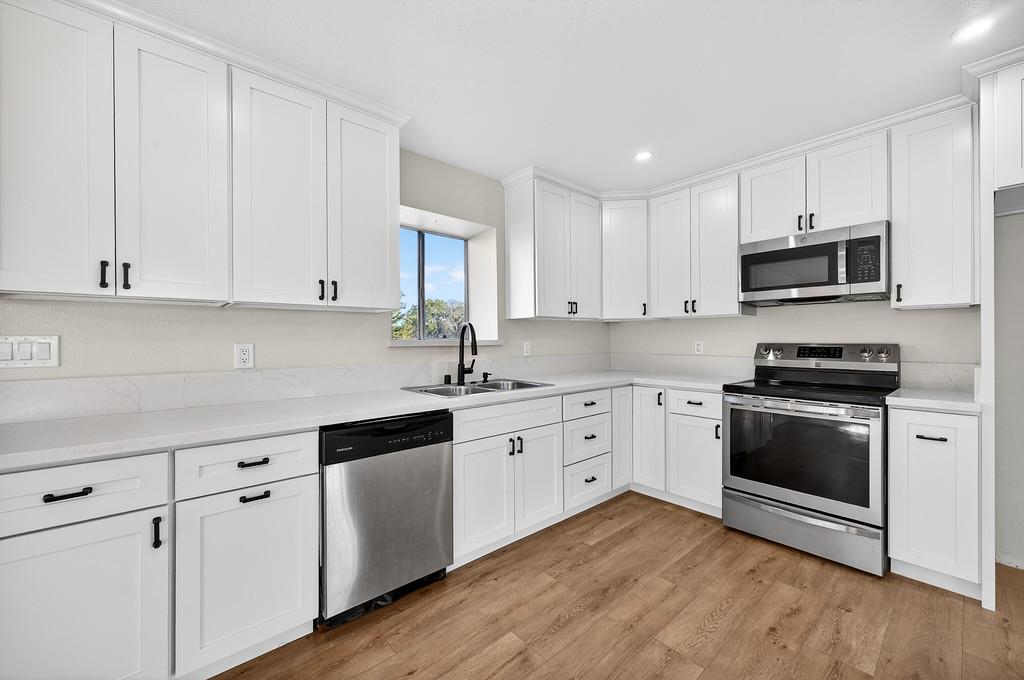 3901 Luneman Road Placerville, CA 95667 - Photo 9 of 56 a kitchen with stainless steel appliances granite countertop a stove a sink and a microwave