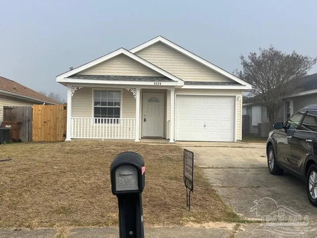 a front view of a house with parking space