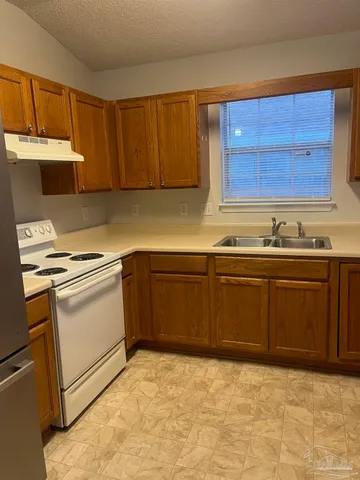 a kitchen with a sink stove and microwave