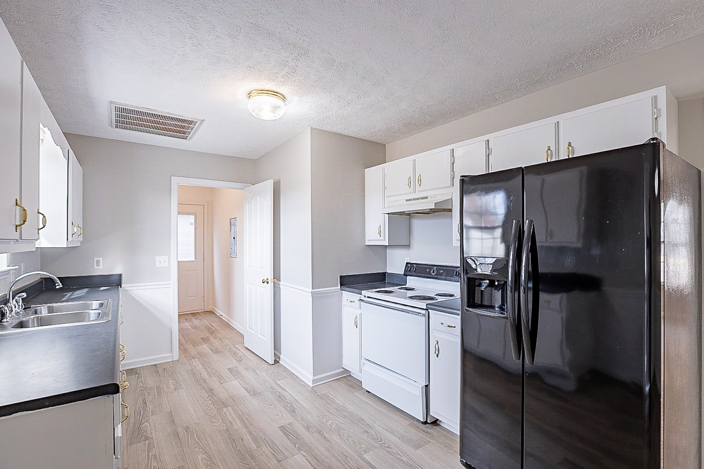 692 Crescent Road Murfreesboro, TN 37128 - Photo 5 of 23 a kitchen with a refrigerator and a stove top oven