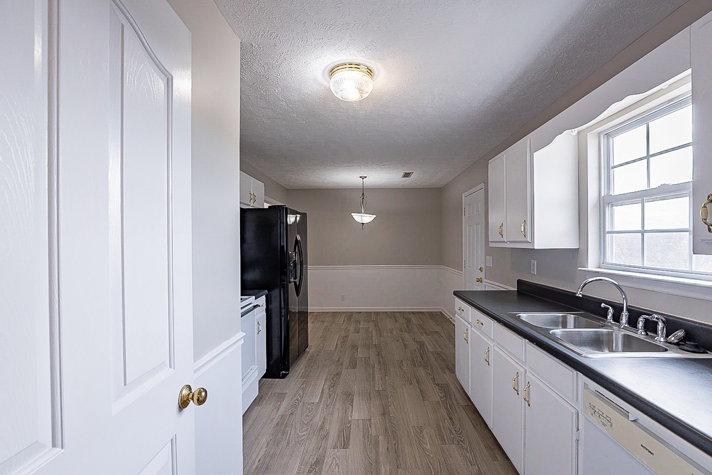 692 Crescent Road Murfreesboro, TN 37128 - Photo 6 of 23 a kitchen with granite countertop a refrigerator a sink and wooden floors