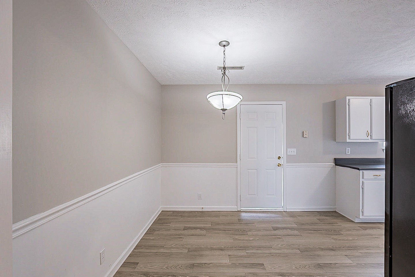 692 Crescent Road Murfreesboro, TN 37128 - Photo 7 of 23 a view of empty room with wooden floor and kitchen