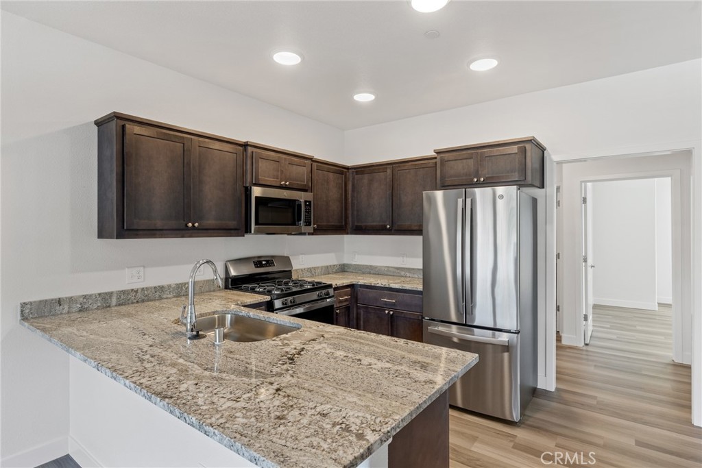 1991 Humboldt Road Chico, CA 95928 - Photo 6 of 12 a kitchen with stainless steel appliances granite countertop a sink refrigerator and microwave