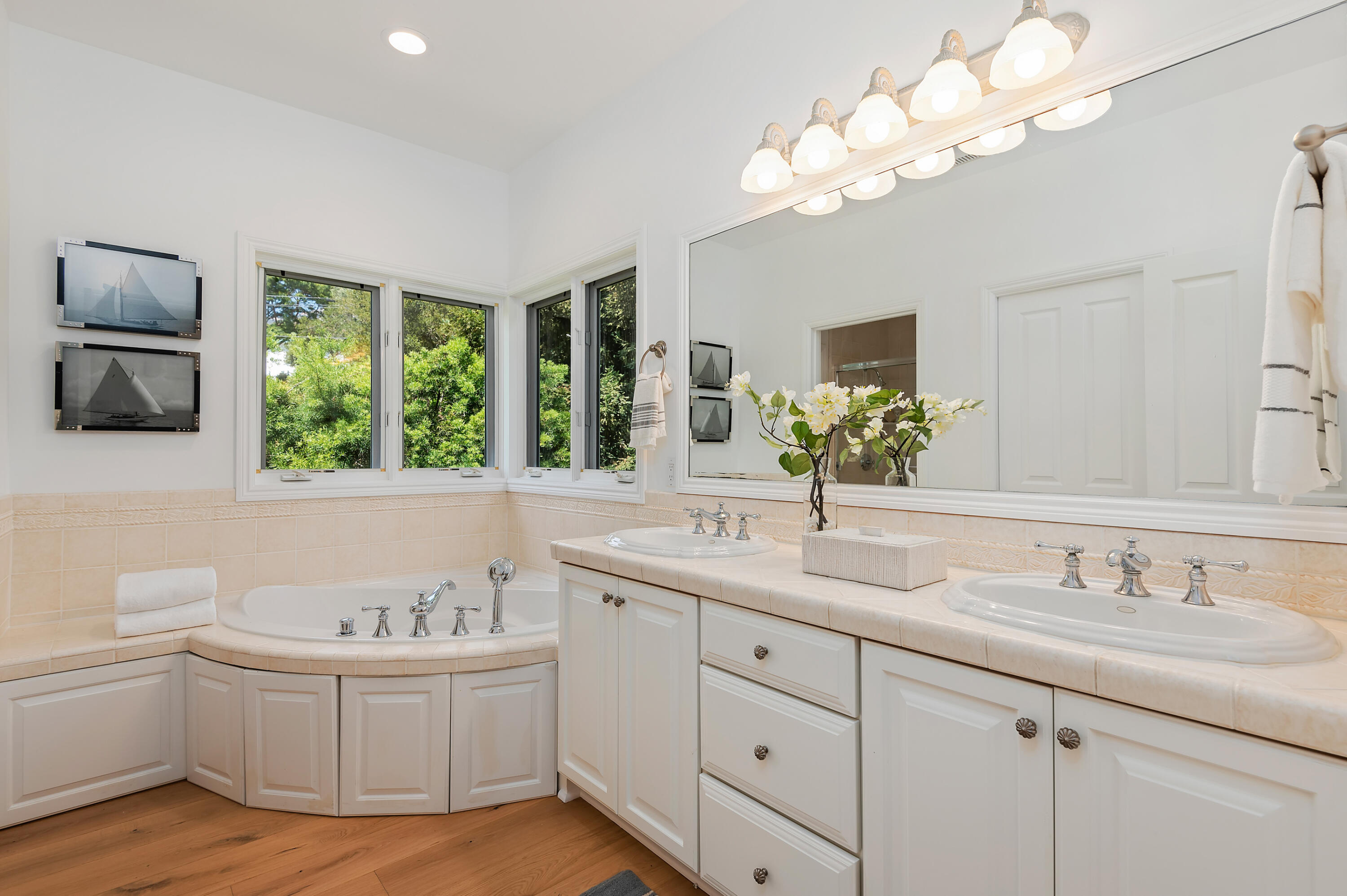 3848-2 Crescent Drive Santa Barbara, CA 93110 - Photo 17 of 32 a bathroom with a granite countertop sink a large mirror and a bathtub with wooden floor