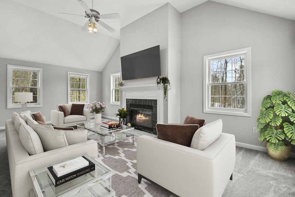 47 Scribner Road Tyngsboro, MA 01879 - Photo 14 of 38 a living room with furniture a flat screen tv and a fireplace