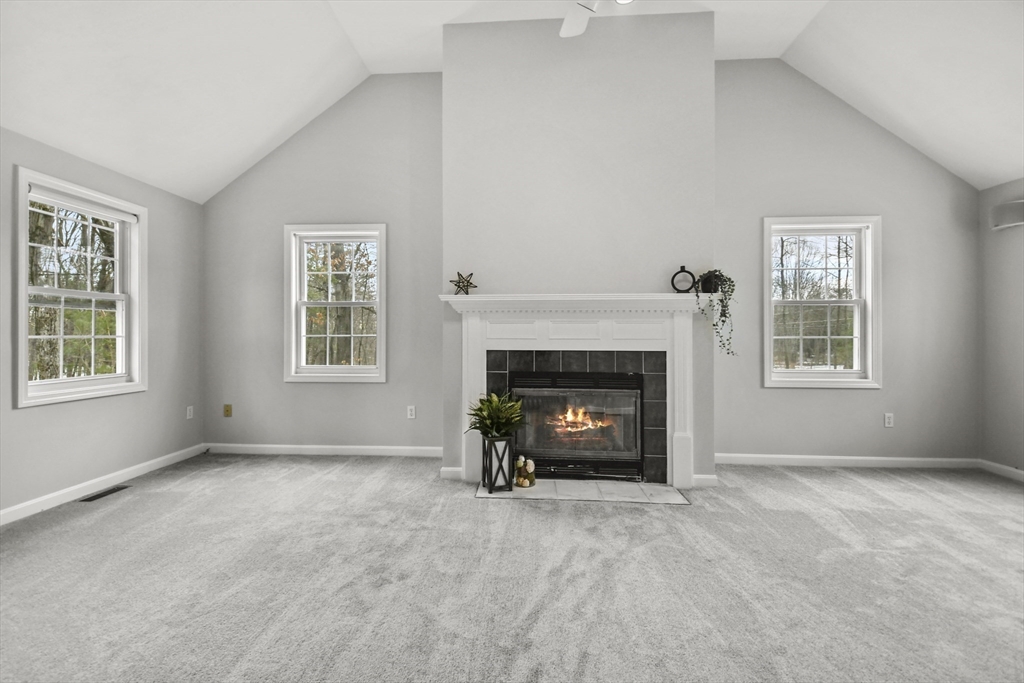 47 Scribner Road Tyngsboro, MA 01879 - Photo 15 of 38 an empty room with windows and fireplace