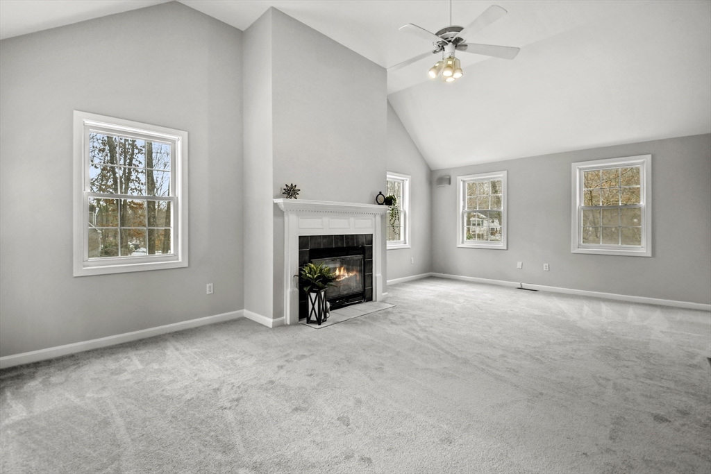 47 Scribner Road Tyngsboro, MA 01879 - Photo 16 of 38 a view of empty room with windows and fireplace