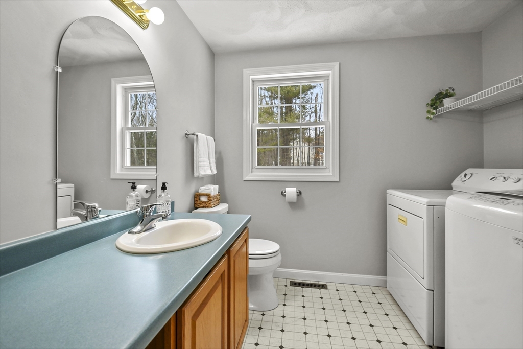 47 Scribner Road Tyngsboro, MA 01879 - Photo 17 of 38 a bathroom with a sink a toilet and a mirror