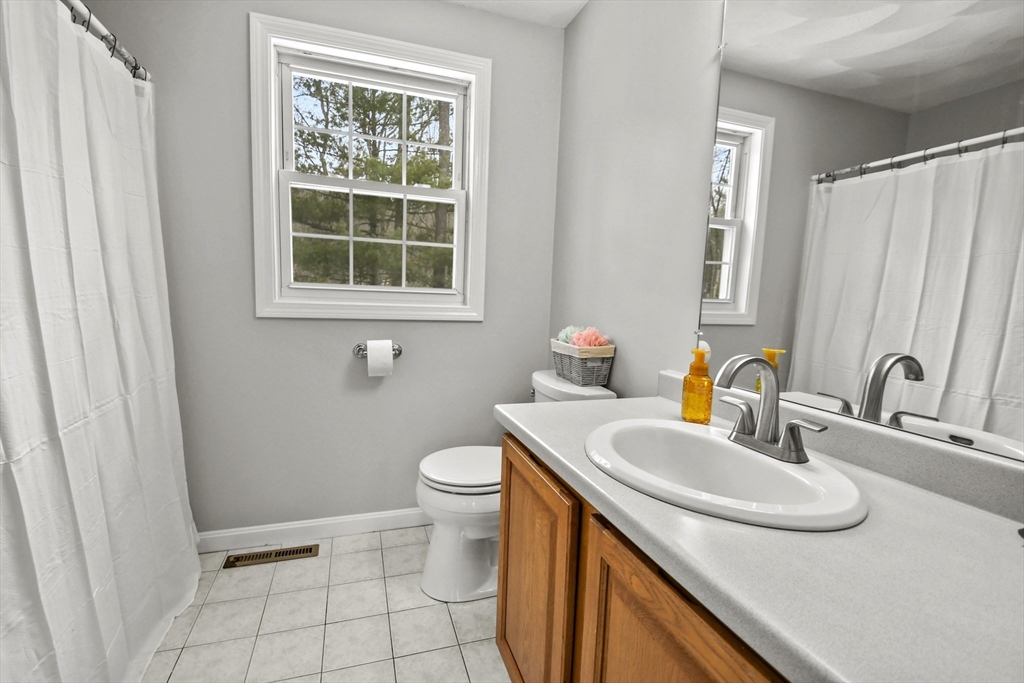 47 Scribner Road Tyngsboro, MA 01879 - Photo 22 of 38 a bathroom with a sink a toilet and a window