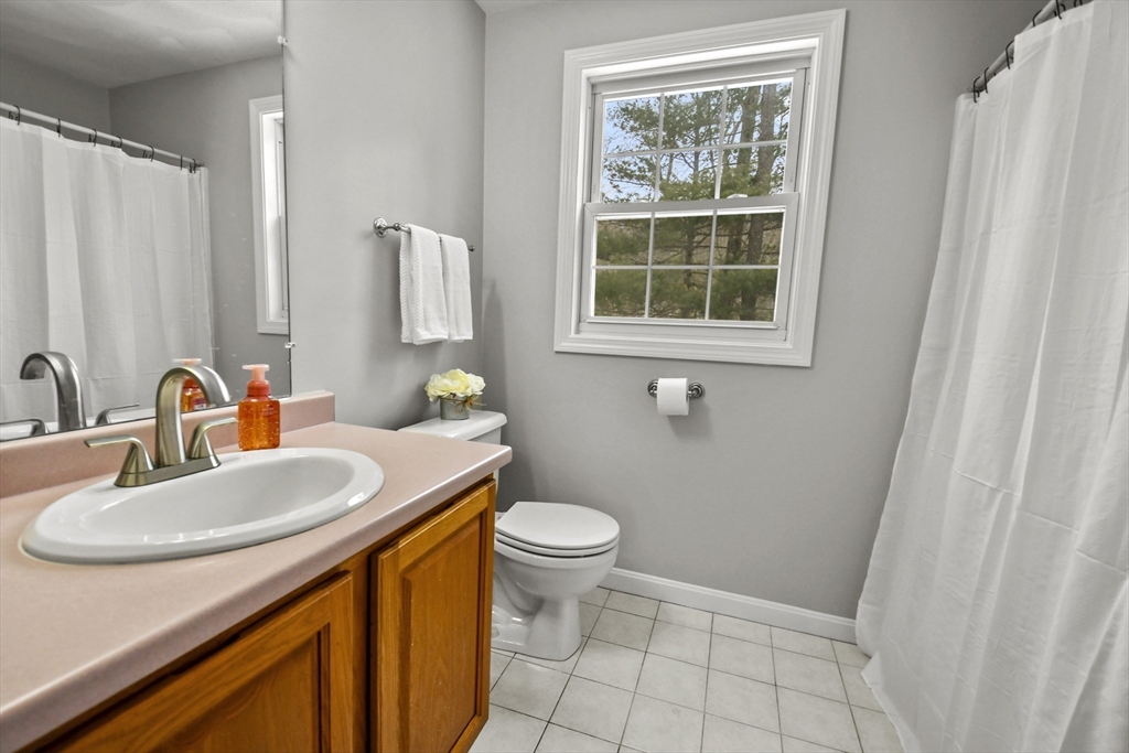 47 Scribner Road Tyngsboro, MA 01879 - Photo 26 of 38 a bathroom with a sink a toilet and a window