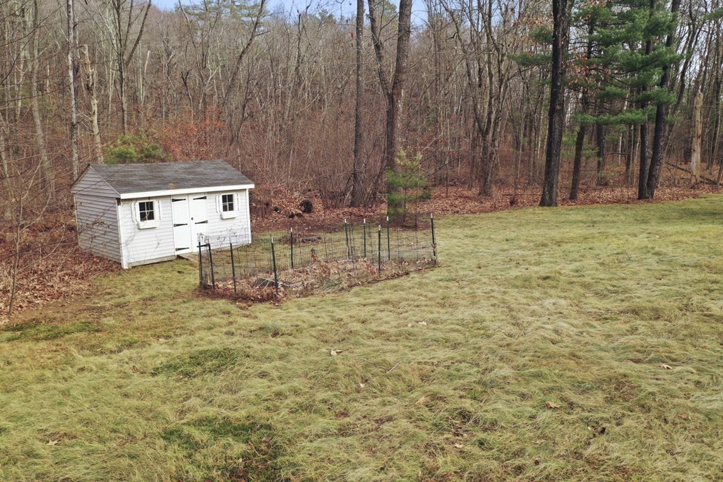 47 Scribner Road Tyngsboro, MA 01879 - Photo 32 of 38 a backyard of a house with table and chairs