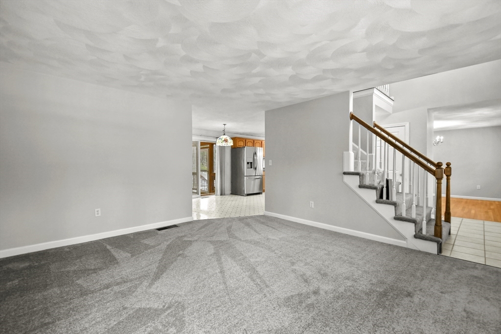 47 Scribner Road Tyngsboro, MA 01879 - Photo 4 of 38 a view of an empty room with stairs