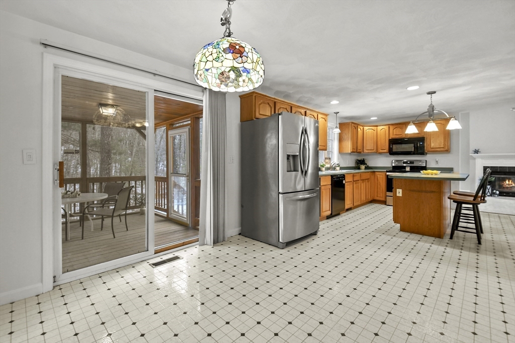 47 Scribner Road Tyngsboro, MA 01879 - Photo 10 of 38 a kitchen with stainless steel appliances kitchen island granite countertop a refrigerator and a sink