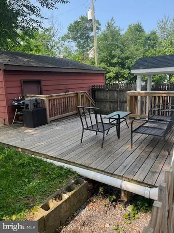 a view of a deck with furniture and a yard