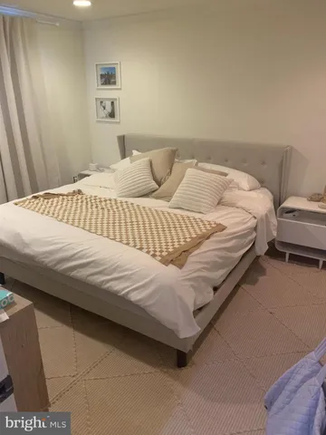 a bedroom with a bed and a couch