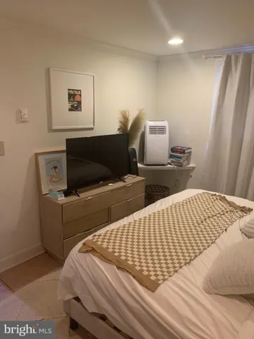 a bedroom with two beds and painting on the wall