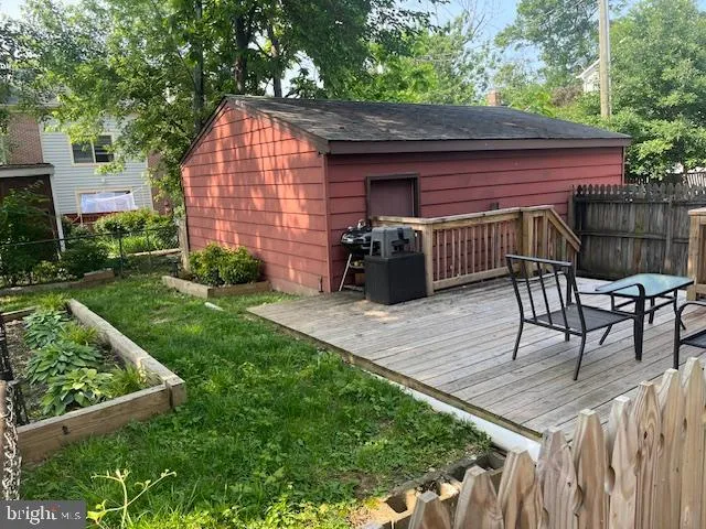 a view of backyard with table and chairs and potted plants