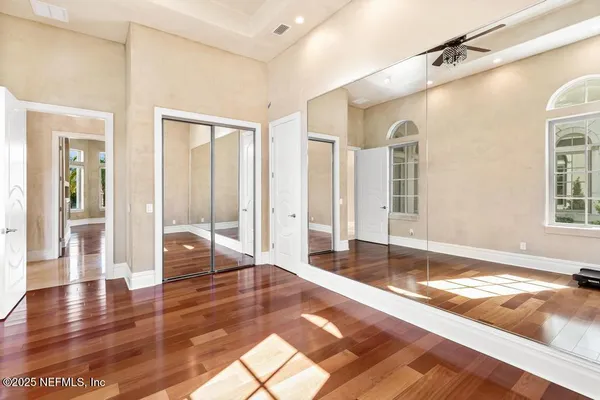 a kitchen with stainless steel appliances granite countertop a refrigerator a sink dishwasher a stove and white countertops with wooden floor