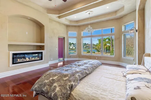 a bathroom with a granite countertop sink a large mirror and a shower