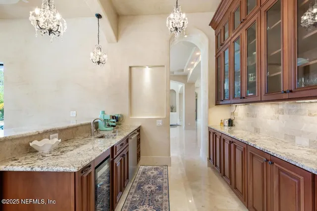 a view of a livingroom with furniture wooden floor chandelier