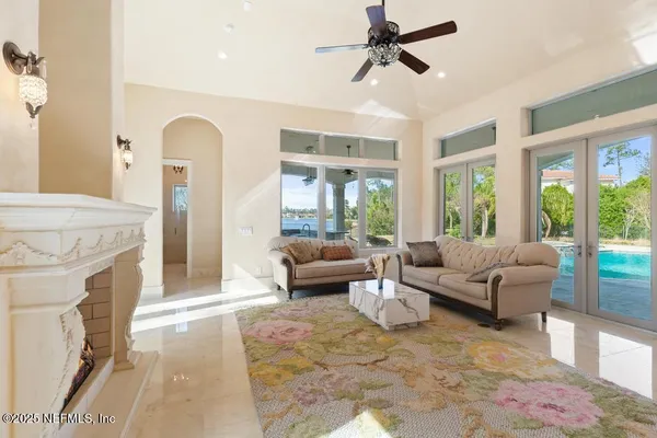 a view of a patio with a table chairs and a swimming pool