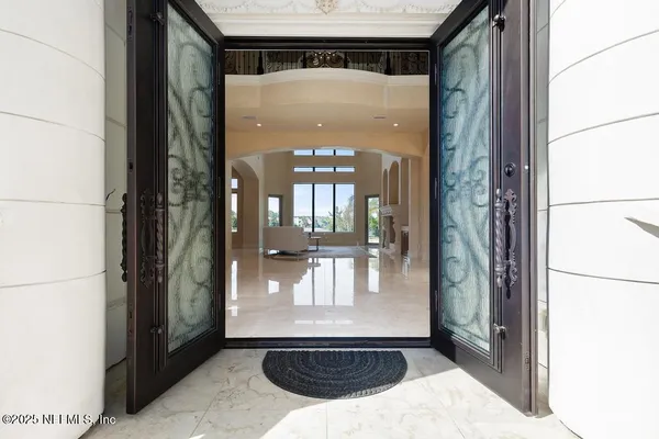 a living room with fireplace furniture and a large window