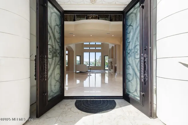 a living room with fireplace furniture and a large window