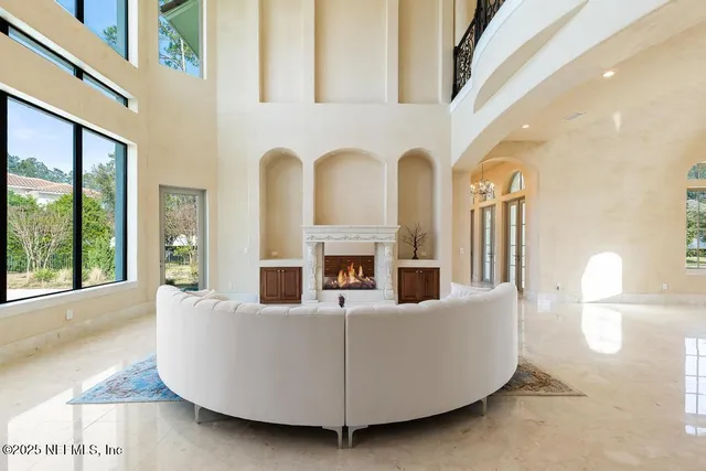 a spacious bedroom with a large bed and a fireplace