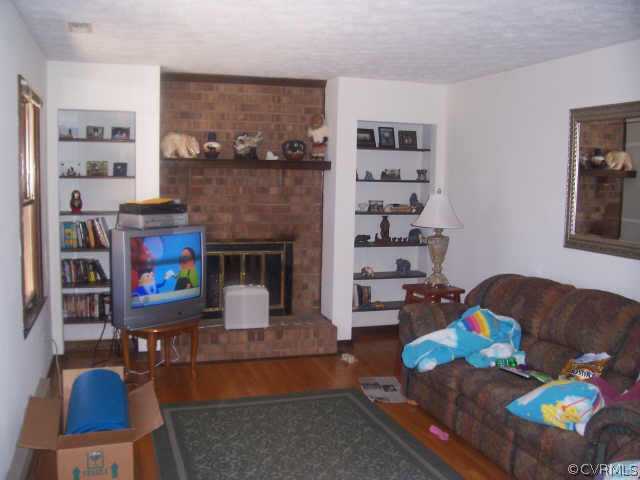 1900 Hawk Town Road Maidens, VA 23102 - Photo 2 of 7 a living room with furniture and a fireplace