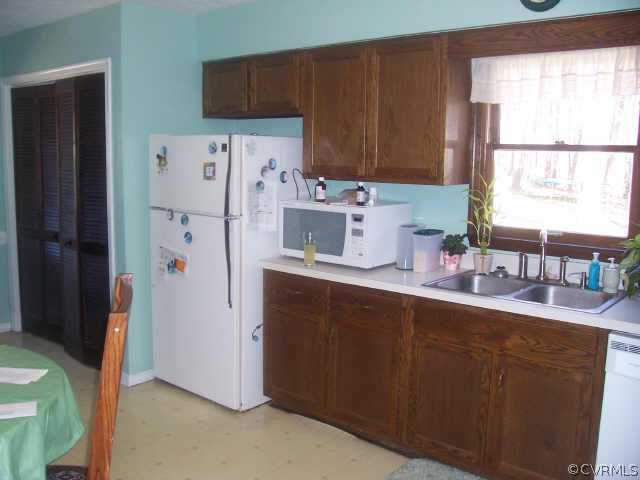 1900 Hawk Town Road Maidens, VA 23102 - Photo 3 of 7 a kitchen with stainless steel appliances a refrigerator a sink a window and cabinets