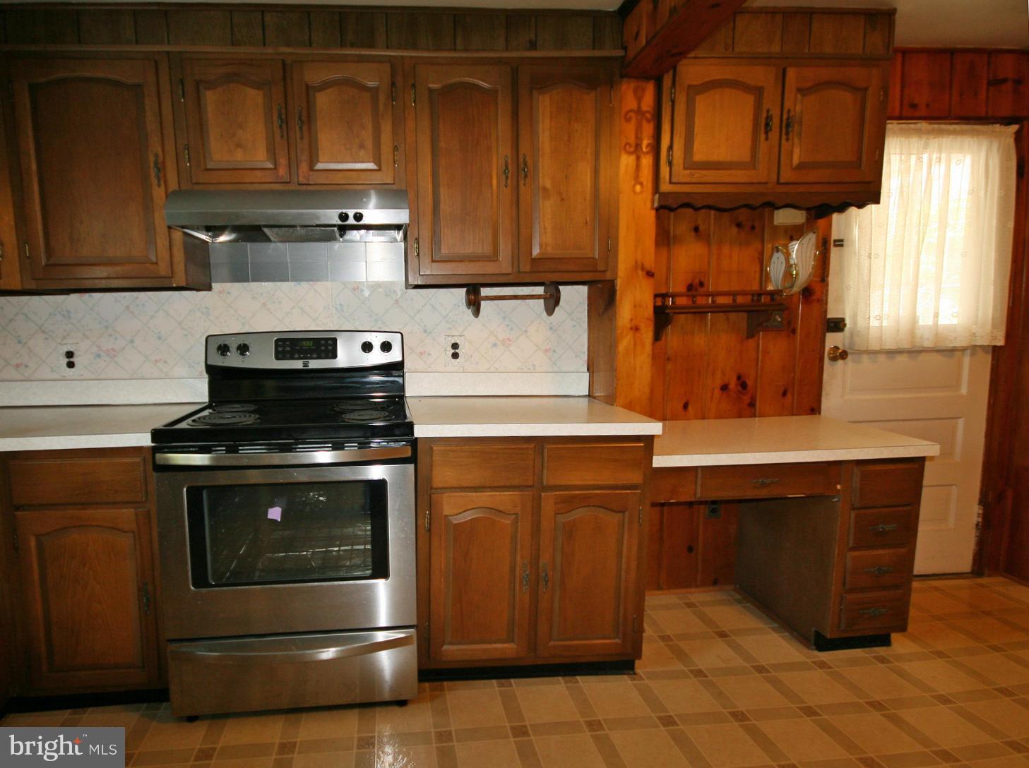 4406 Maple Road Morningside, MD 20746 - Photo 14 of 19 a kitchen with stainless steel appliances granite countertop a stove and a microwave