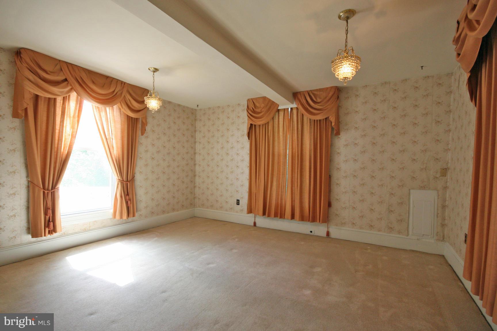 4406 Maple Road Morningside, MD 20746 - Photo 3 of 19 an empty room with a window and a chandelier