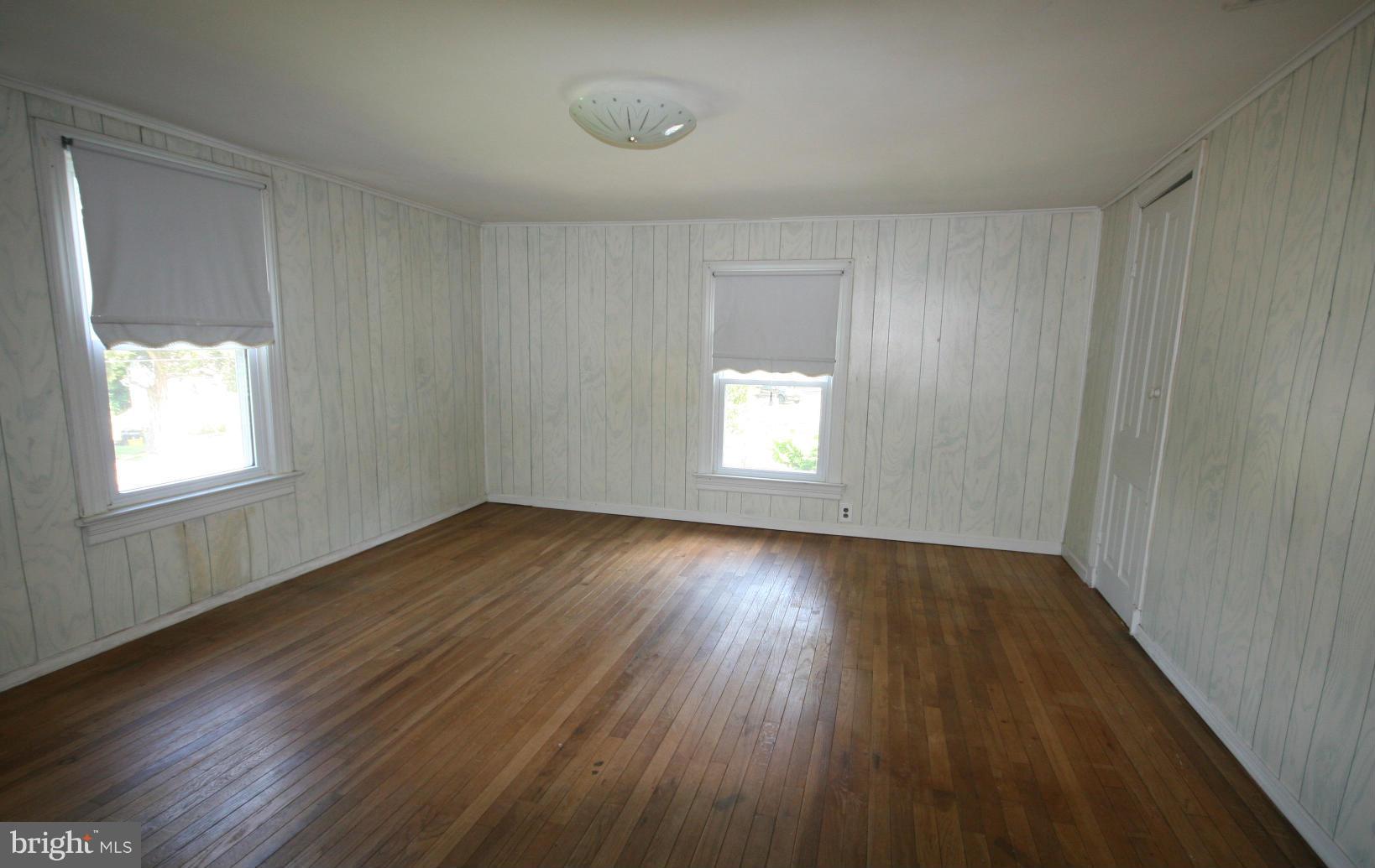 4406 Maple Road Morningside, MD 20746 - Photo 7 of 19 an empty room with wooden floor and windows