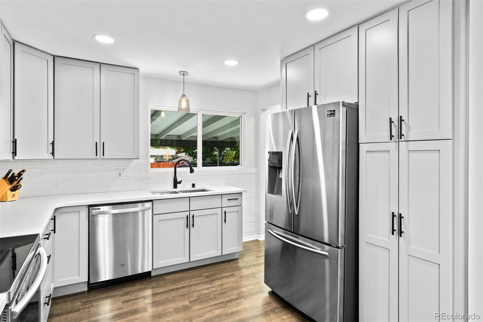 6000 Garrison Street Arvada, CO 80004 - Photo 16 of 50 a kitchen with stainless steel appliances a refrigerator sink and cabinets