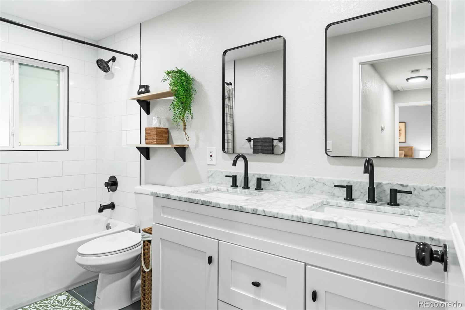 6000 Garrison Street Arvada, CO 80004 - Photo 23 of 50 a bathroom with a granite countertop toilet sink and a mirror