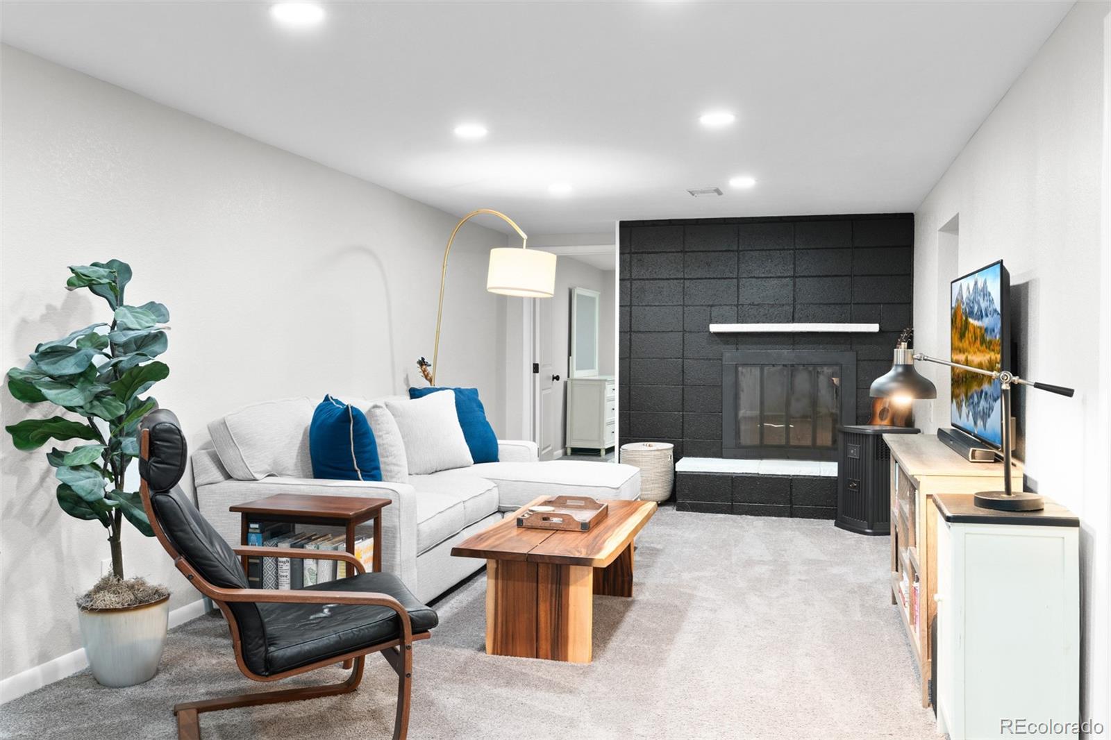 6000 Garrison Street Arvada, CO 80004 - Photo 24 of 50 a living room with furniture and a flat screen tv