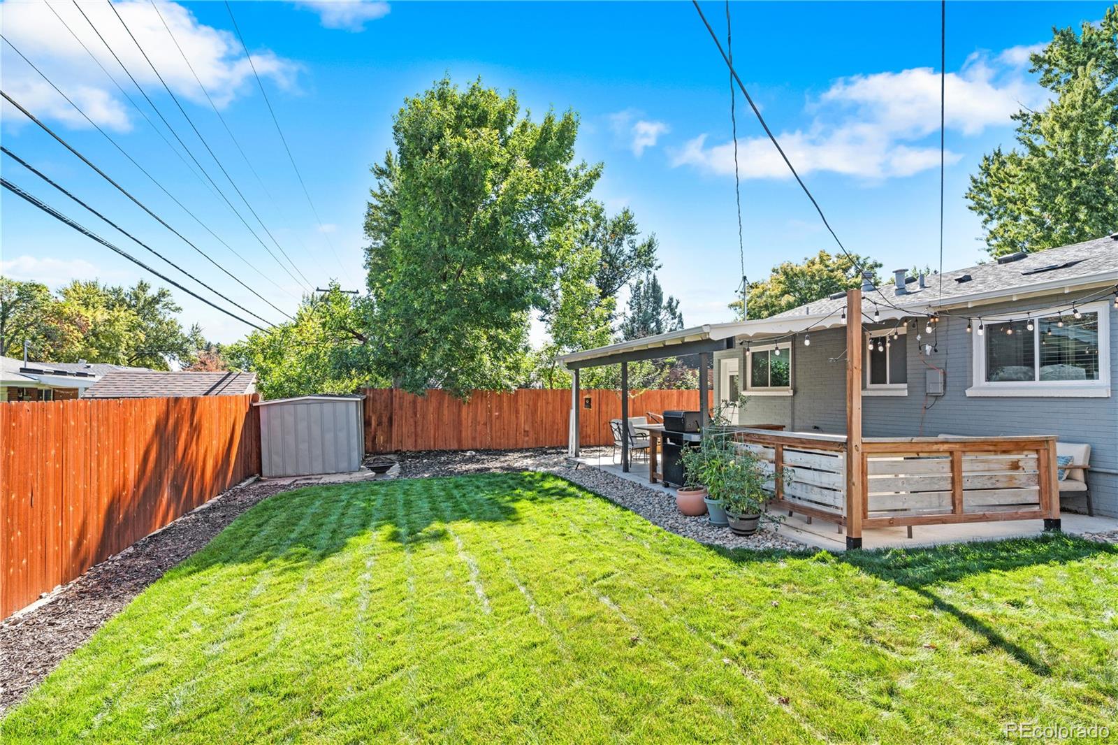 6000 Garrison Street Arvada, CO 80004 - Photo 36 of 50 a view of a backyard with plants and a garden