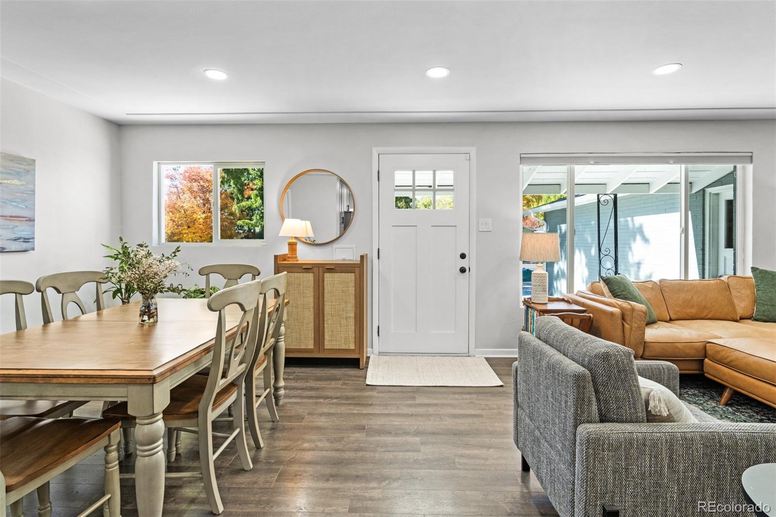 6000 Garrison Street Arvada, CO 80004 - Photo 5 of 50 a living room with furniture a wooden floor and a large window