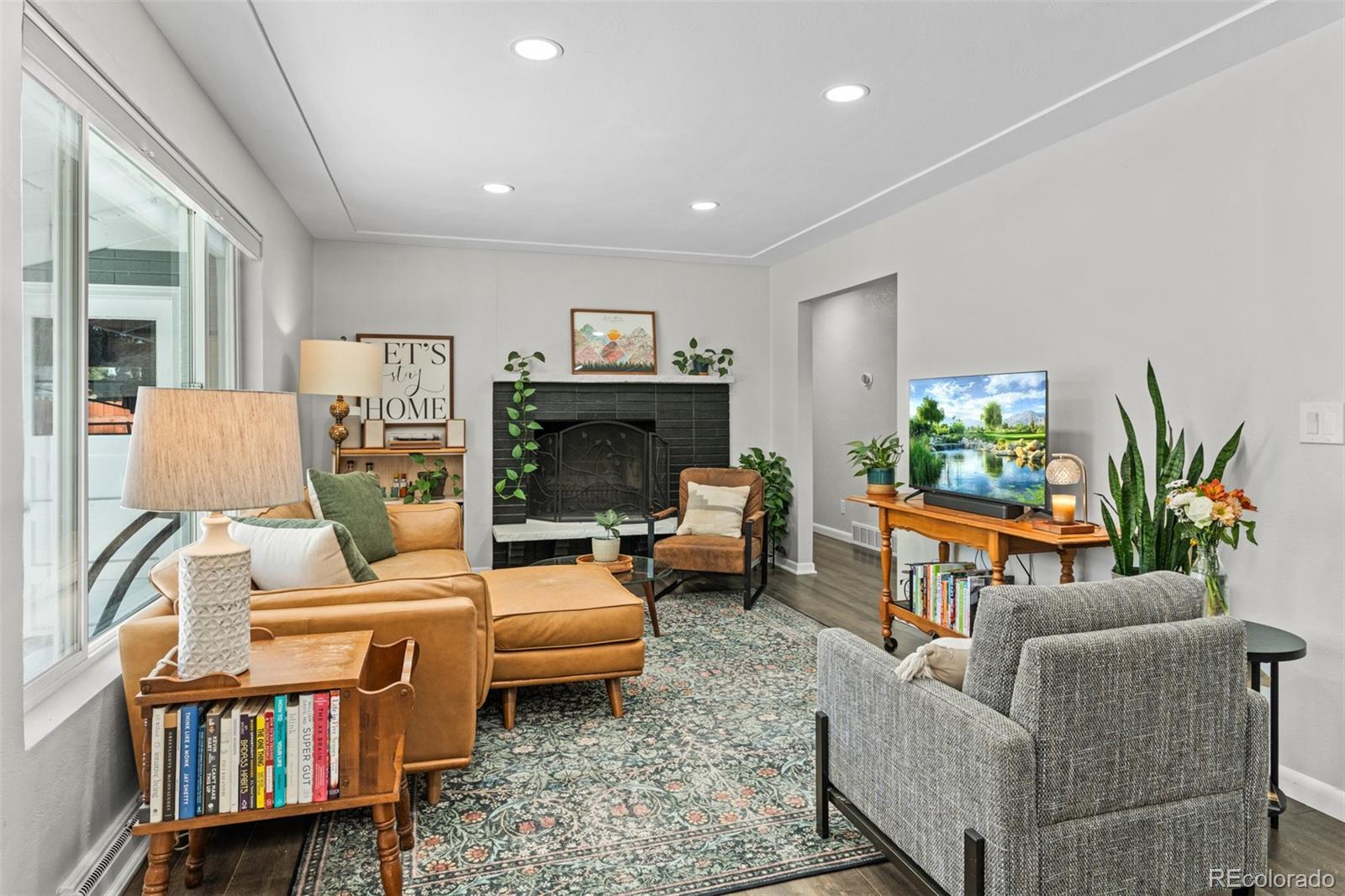 6000 Garrison Street Arvada, CO 80004 - Photo 6 of 50 a living room with furniture and a fireplace