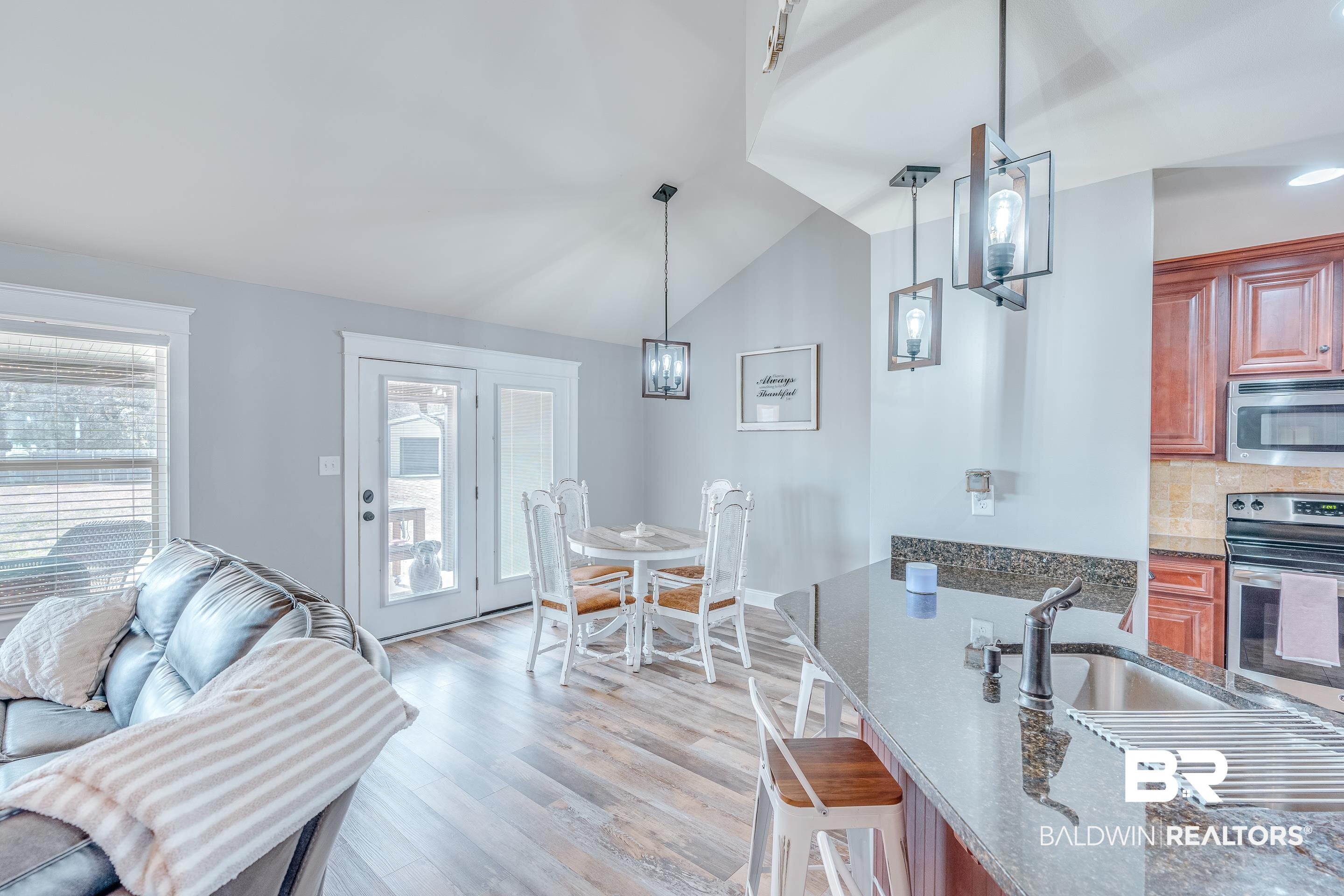 13235 Tom Gaston Road Mobile, AL 36695 - Photo 8 of 43 Kitchen featuring lofted ceiling, sink, appliances with stainless steel finishes, light hardwood / wood-style floors, and decorative light fixtures
