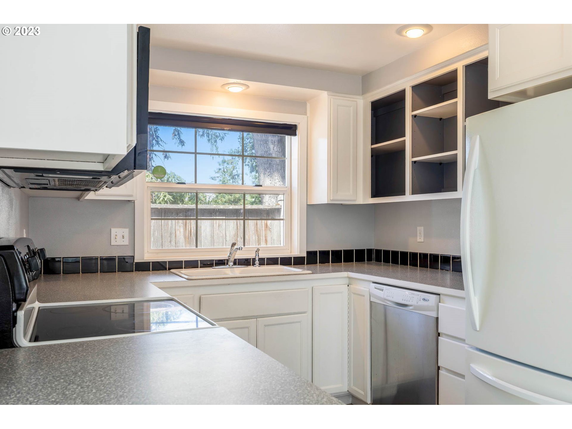 3595 Arbor Avenue Eugene, OR 97402 - Photo 11 of 26 a kitchen with a sink a counter top space cabinets and a window