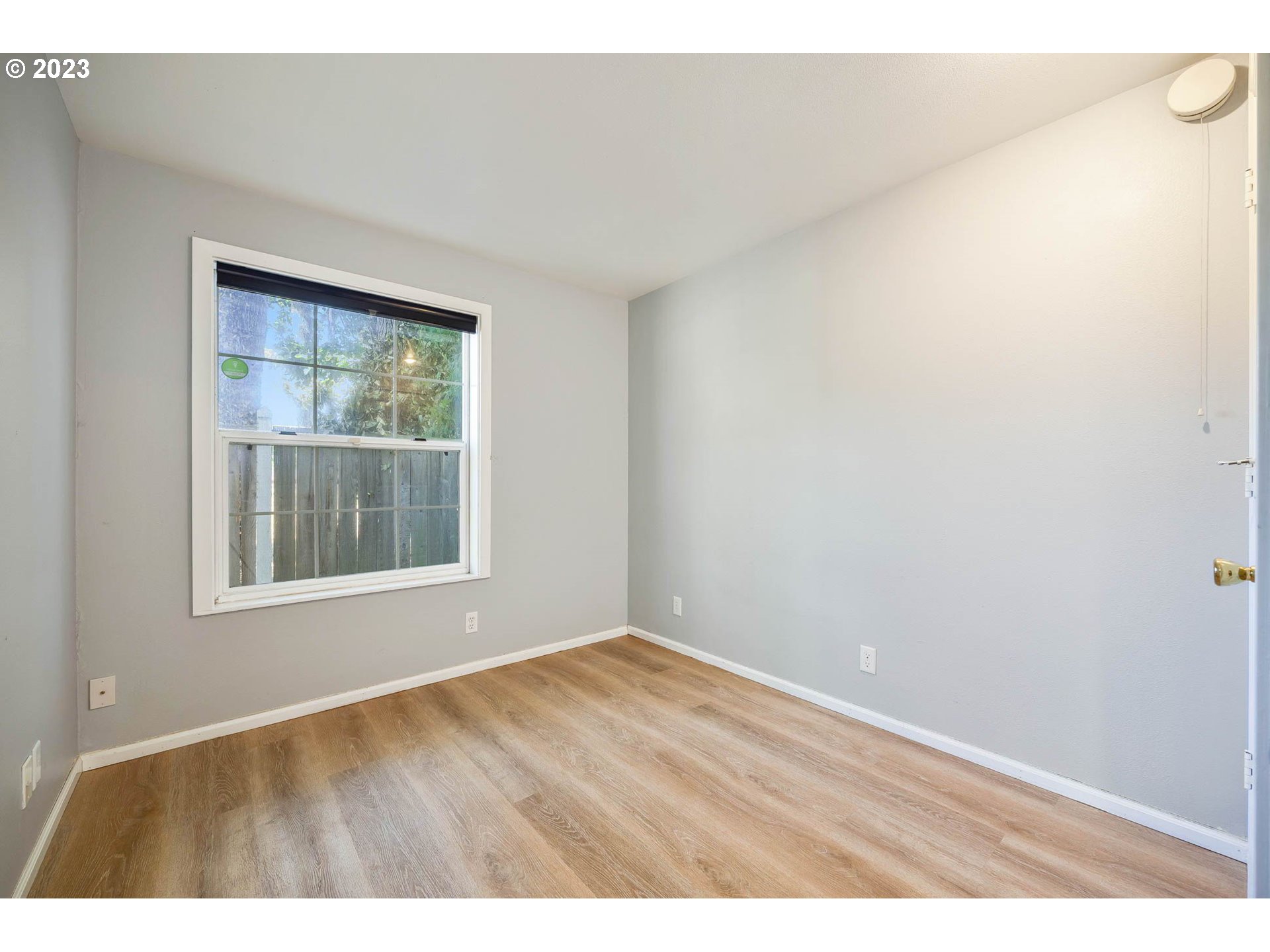 3595 Arbor Avenue Eugene, OR 97402 - Photo 13 of 26 an empty room with wooden floor and windows