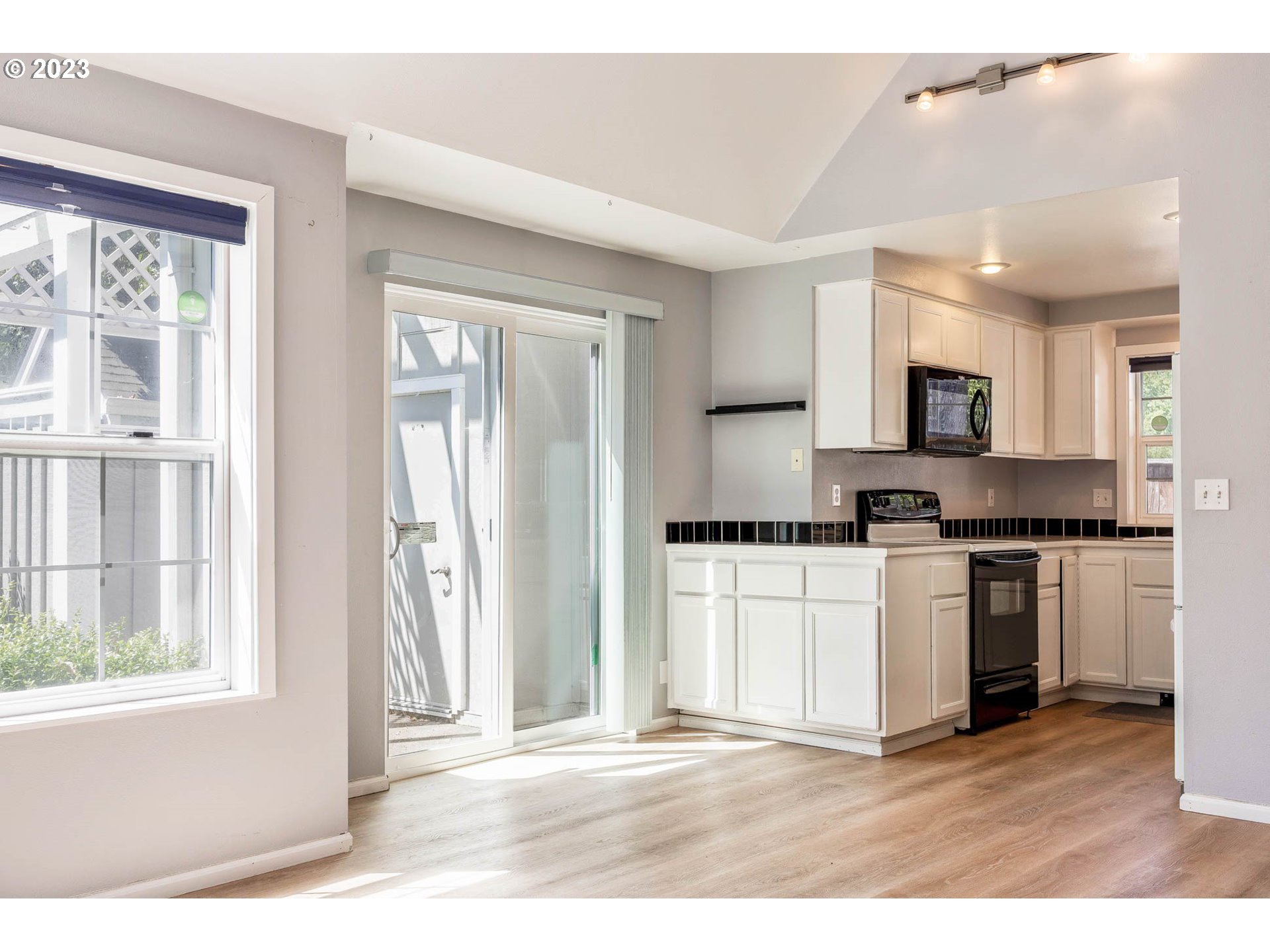 3595 Arbor Avenue Eugene, OR 97402 - Photo 9 of 26 a kitchen with granite countertop a stove a sink and a microwave
