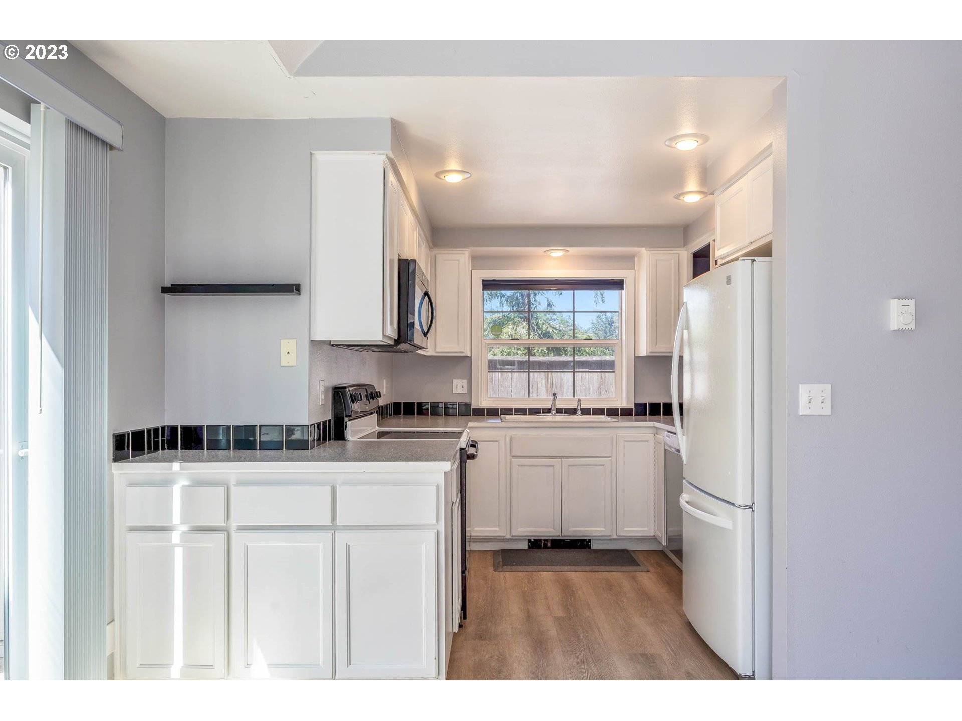 3595 Arbor Avenue Eugene, OR 97402 - Photo 10 of 26 a kitchen with granite countertop a sink stove and refrigerator