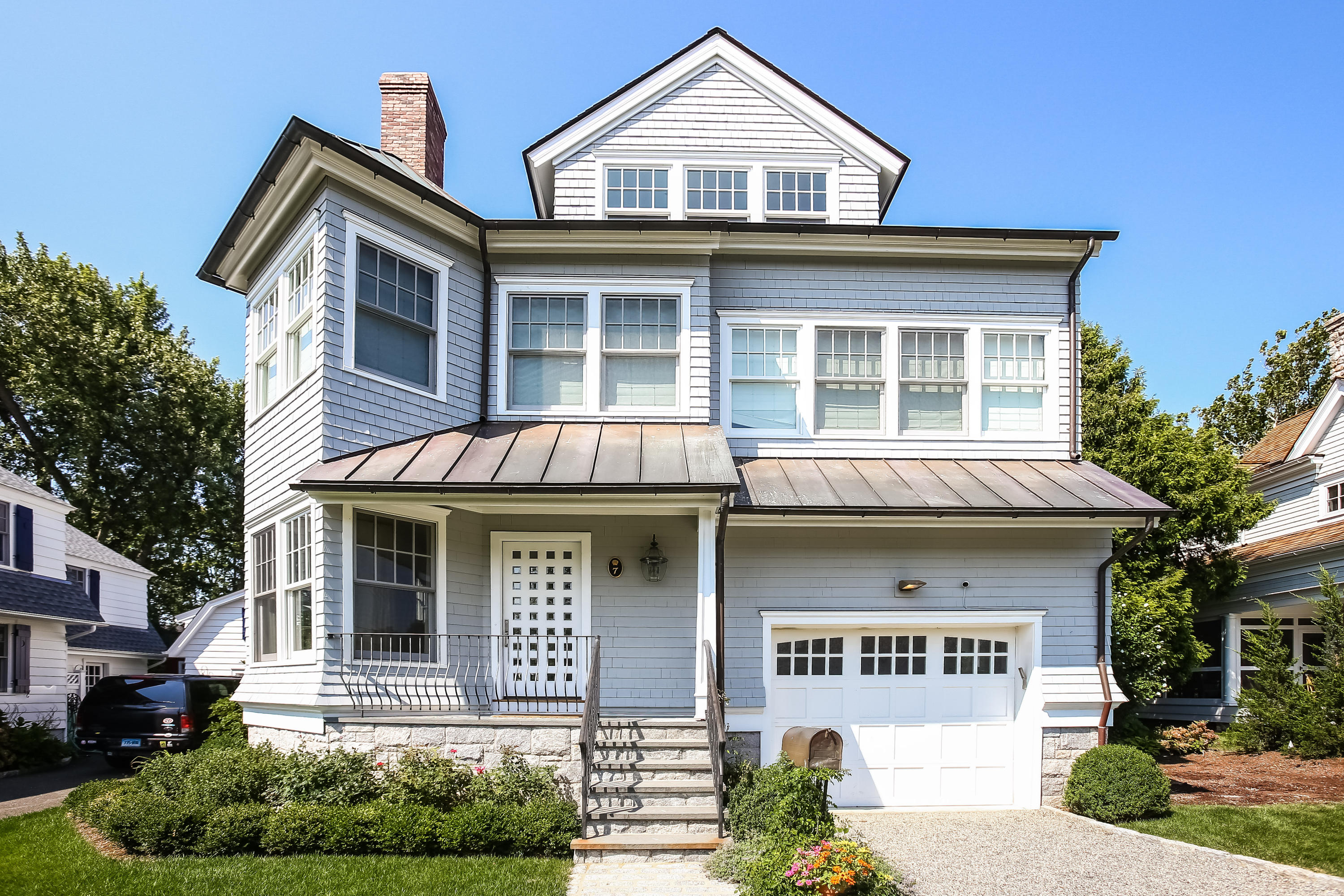 7 Sunwich Road Rowayton, CT 06853 - Photo 1 of 33 a front view of a residential apartment building with a yard and potted plants