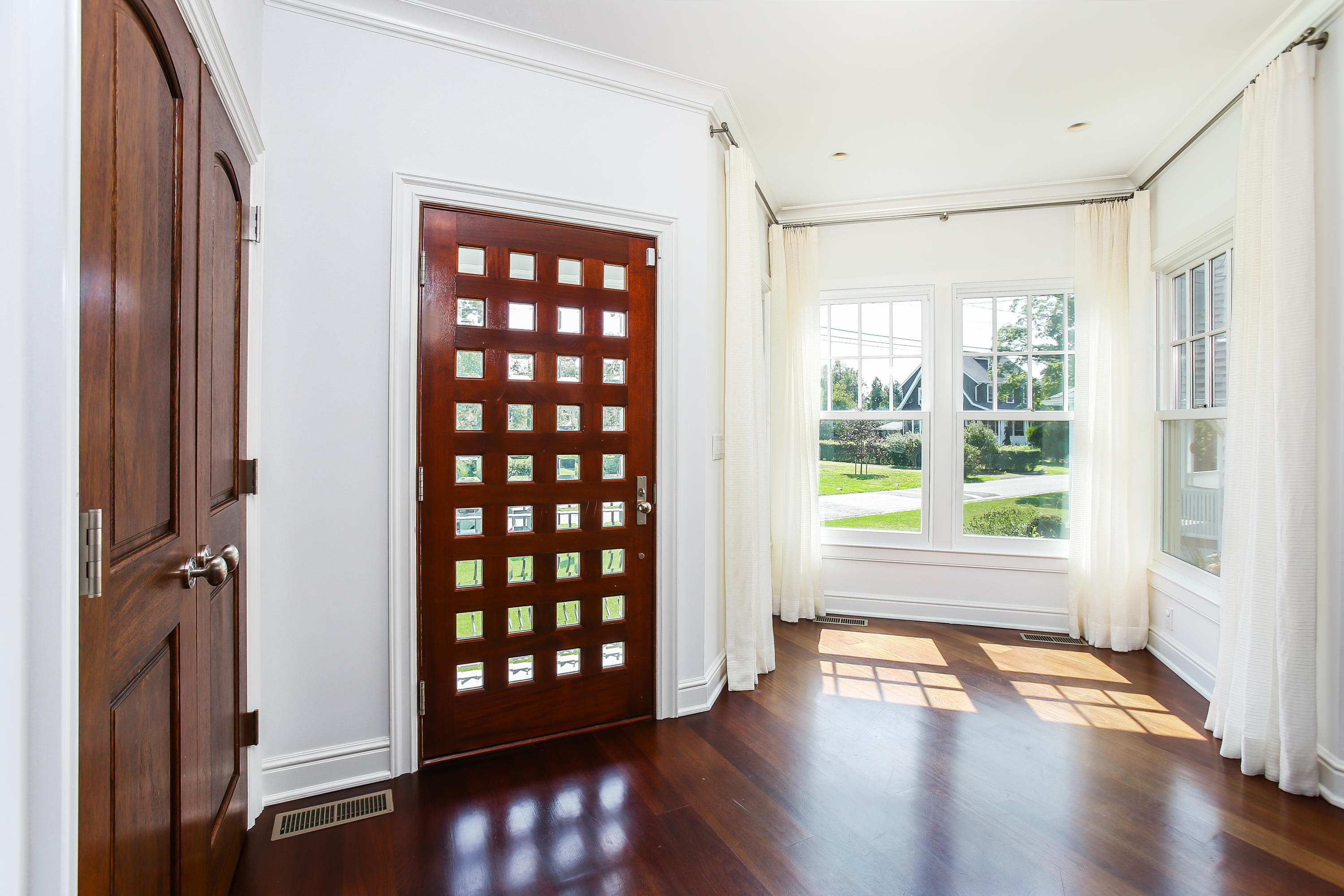 7 Sunwich Road Rowayton, CT 06853 - Photo 5 of 33 a view of an empty room with wooden floor and a window
